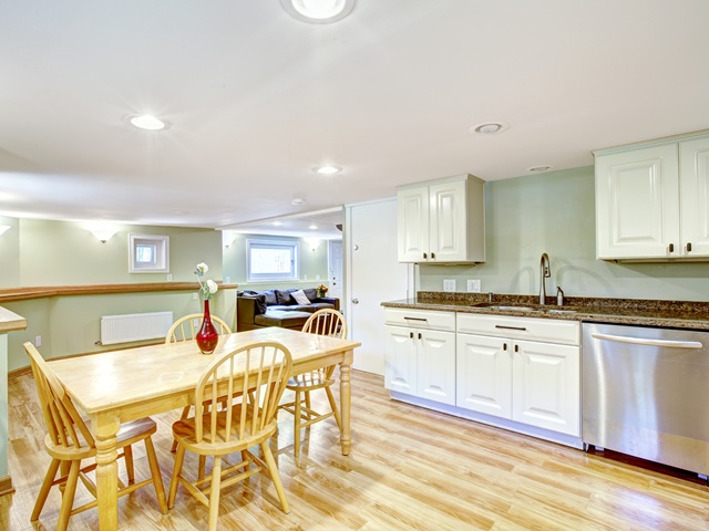 basement unit showing updated kitchen and floors with lots of lighting