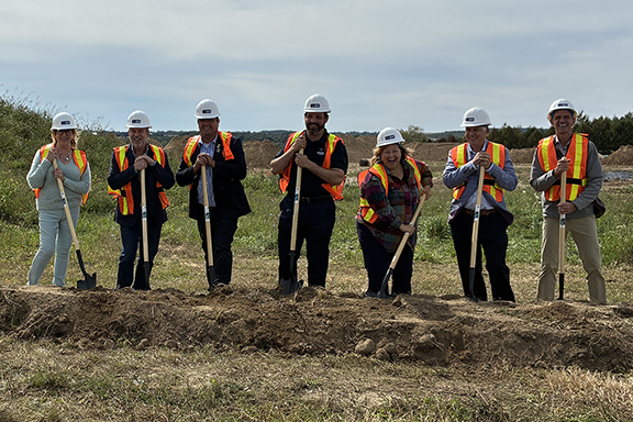 A group of dignitaries stand with shovels for a ceremonial ground turning at the site of the Eastridge Road Community Housing development in Walkerton. From left: Kym Hutcheon, deputy mayor, Municipality of Brockton; John Peevers, senior advisor, corporate affairs, Bruce Power; Don Murray, deputy warden, Bruce County; Luke Charbonneau, warden, Bruce County; the Honourable Lisa Thompson, M.P.P and minister of rural affairs; Chris Peabody, councillor, Bruce County; and Gregory J. McLean, councillor, Municipality of Brockton.