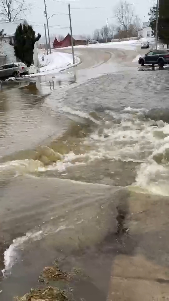The Teeswater River overflows and runs across Bruce Road 15 in Pinkerton.