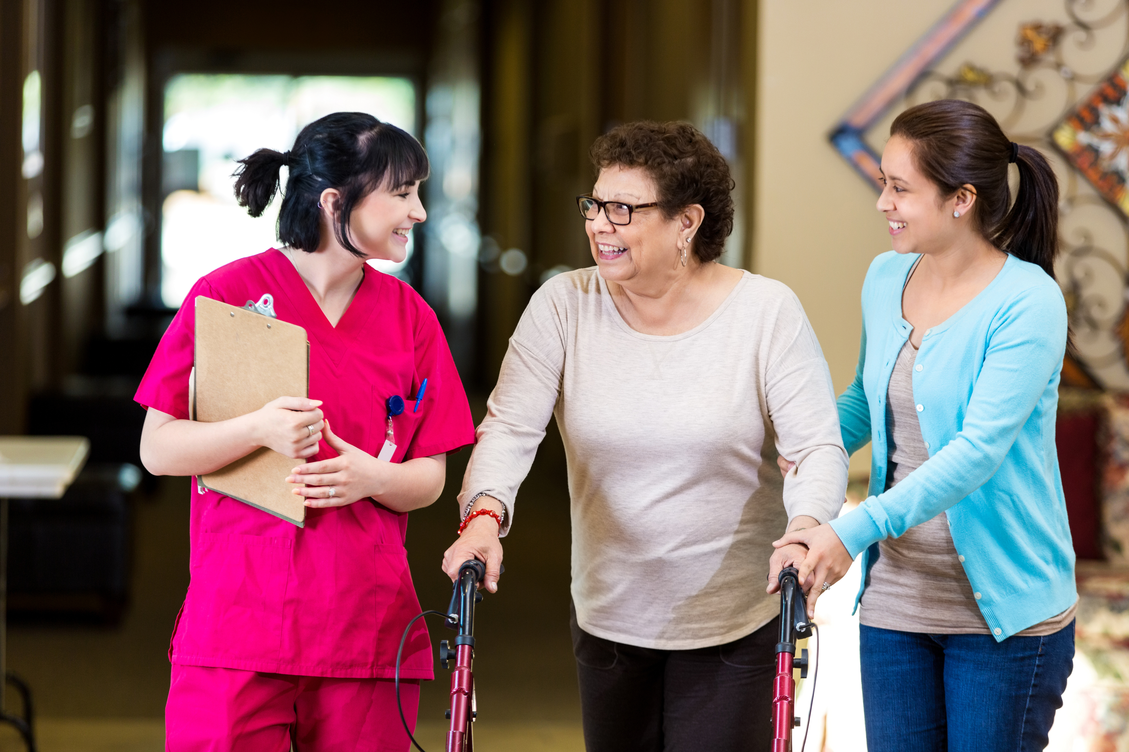 caretakers helping a person in a care home