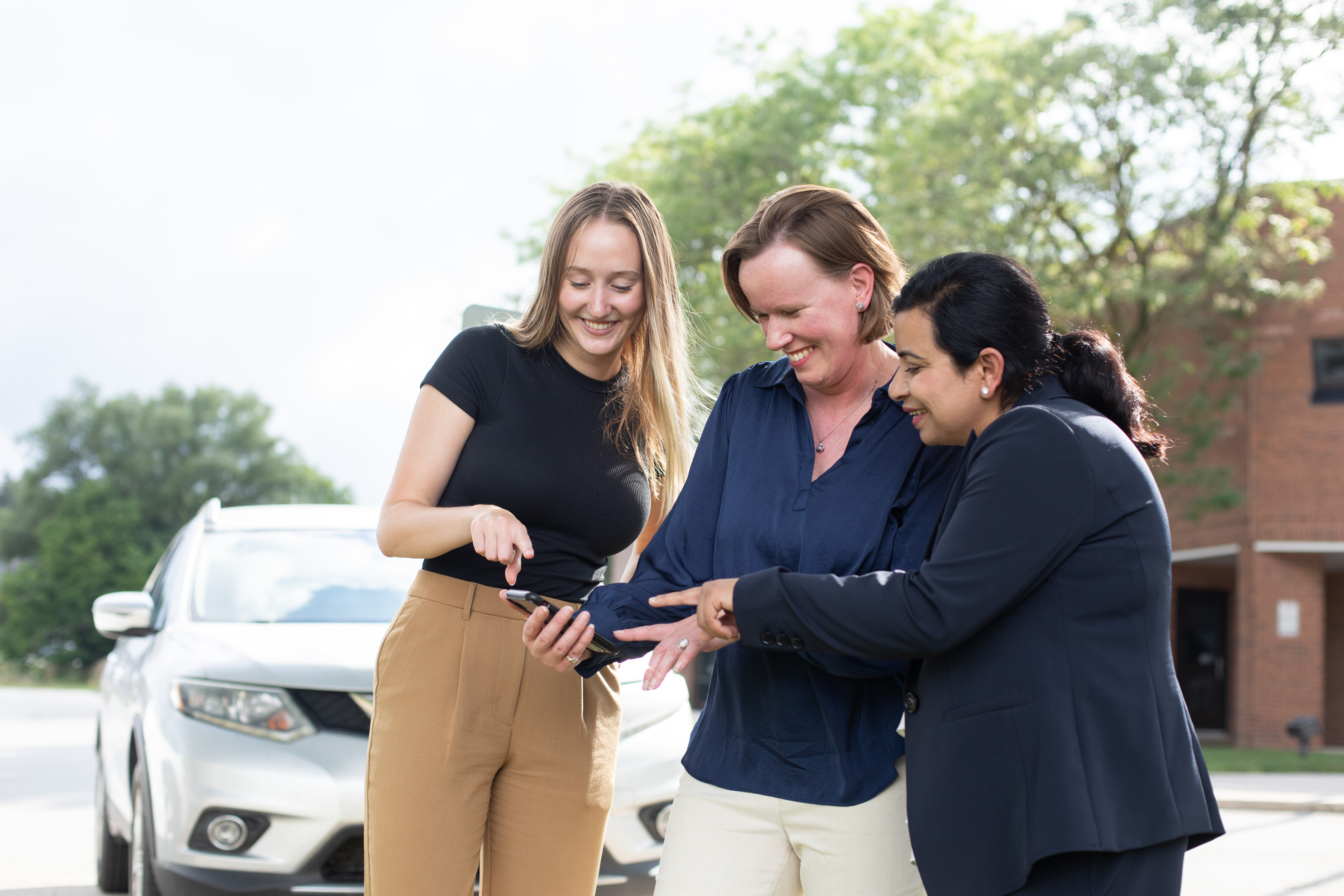 Three people discussing over a phone