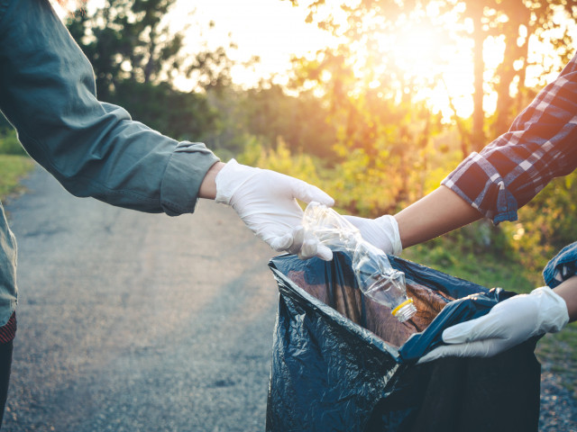 women volunteering help garbage collection beside road