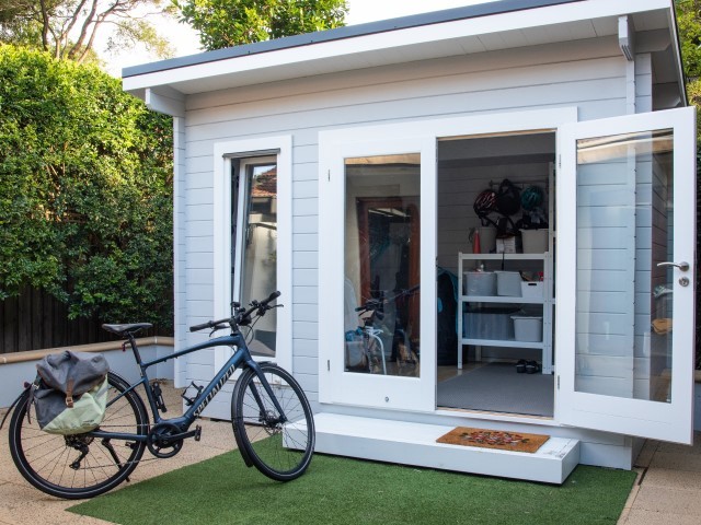 backyard aru with bicycle and welcome mat with open door
