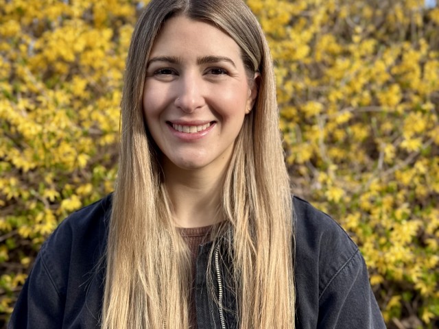 Emily Kussman pictured in front of fall foliage