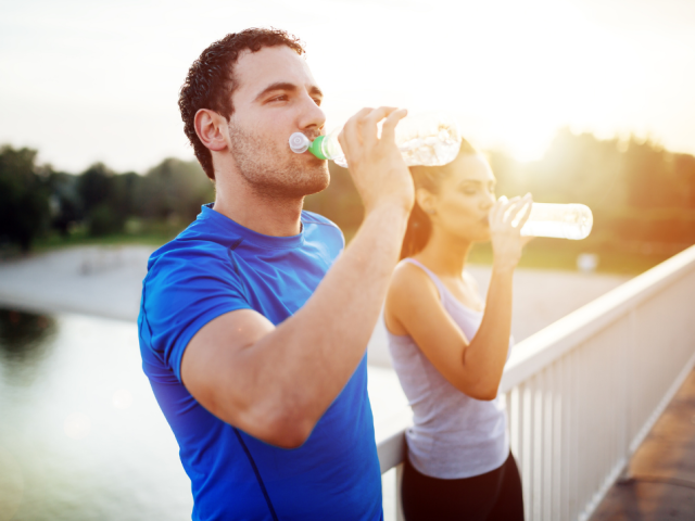 two_people_drinking_water_in_a_water_bottle