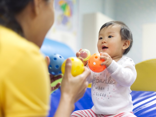 child playing with balls