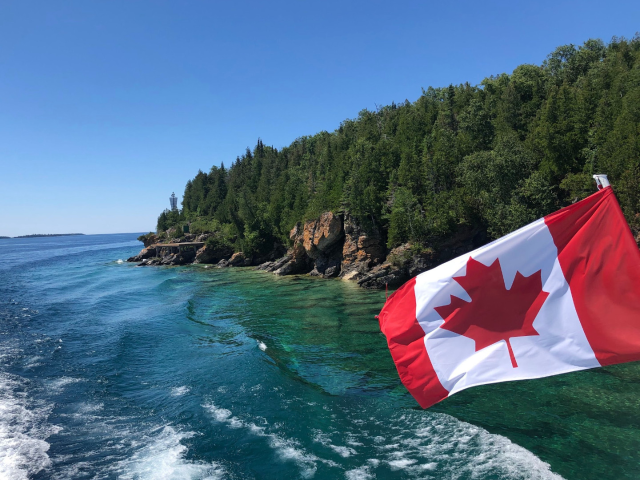Canadian flag flying off boat on Bruce Peninsula